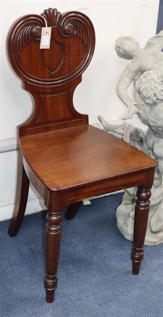 Two Regency carved mahogany hall chairs